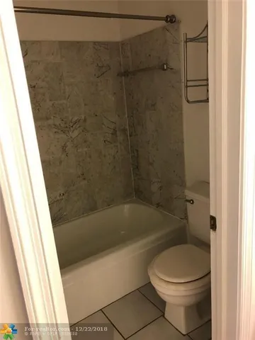 a bathroom with a bathtub and a toilet