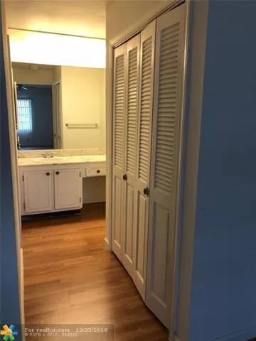 a bathroom with a granite countertop sink and a bathtub
