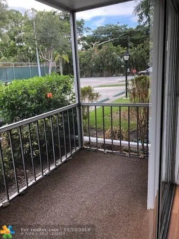 a view of a outdoor space with a floor to ceiling window