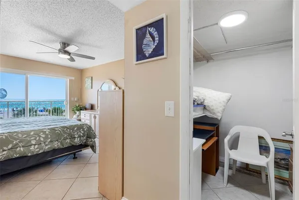 a bathroom with a granite countertop sink a toilet a mirror and shower