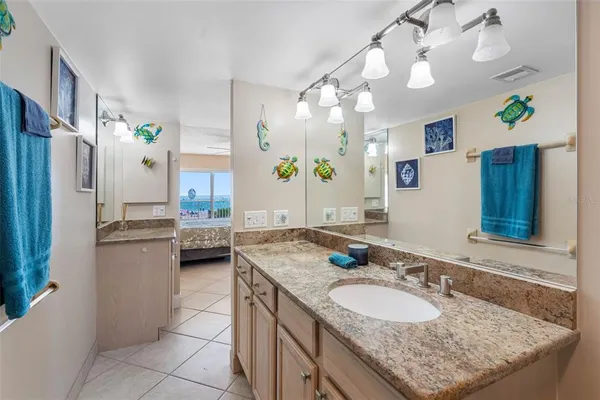 a bathroom with a sink a toilet a mirror and shower