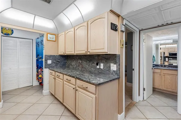 a kitchen with stainless steel appliances granite countertop a sink refrigerator and microwave
