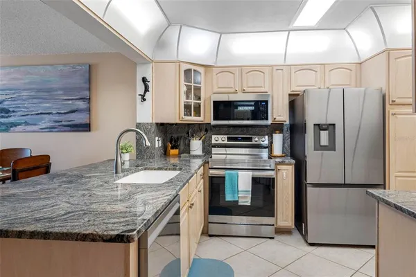 a kitchen with stainless steel appliances granite countertop a stove and a sink