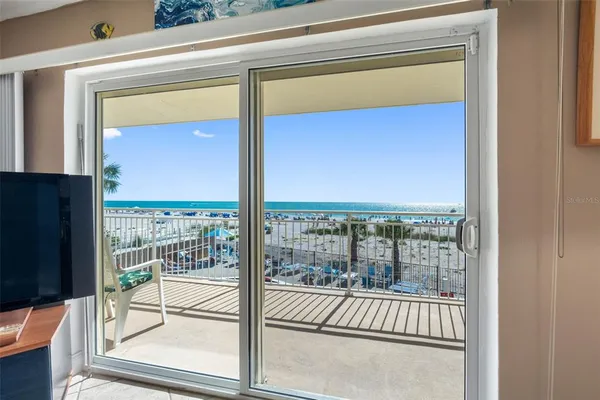 a view of a balcony with floor to ceiling windows and wooden floor