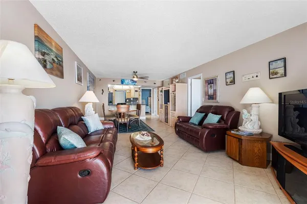 a living room with furniture a rug and a painting on the wall