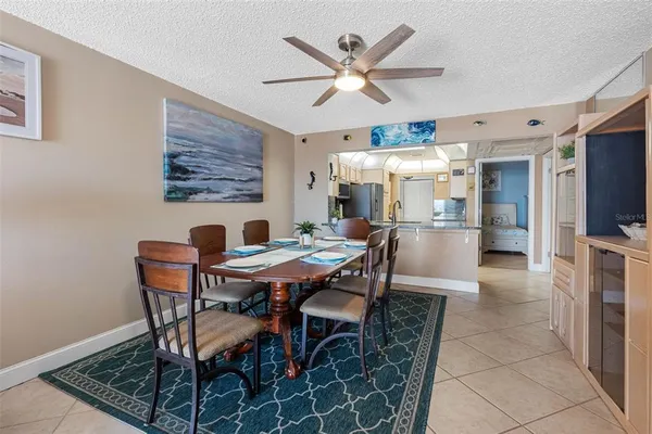 a very nice looking hallway with a flower pot and a refrigerator