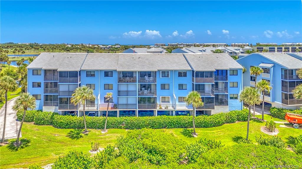 10 Northeast Plantation Road, Unit 101 Jensen Beach, FL 34957 - Photo 21 of 53 a view of a swimming pool with a garden and plants