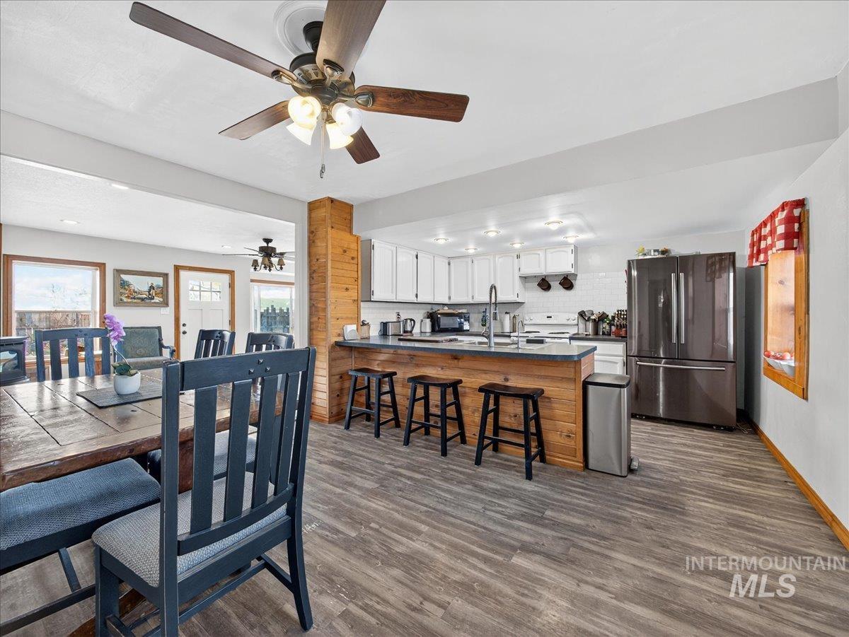 2588 West Sales Yard Road Emmett, ID 83617 - Photo 17 of 49 Dining space featuring dark wood-style floors and ceiling fan