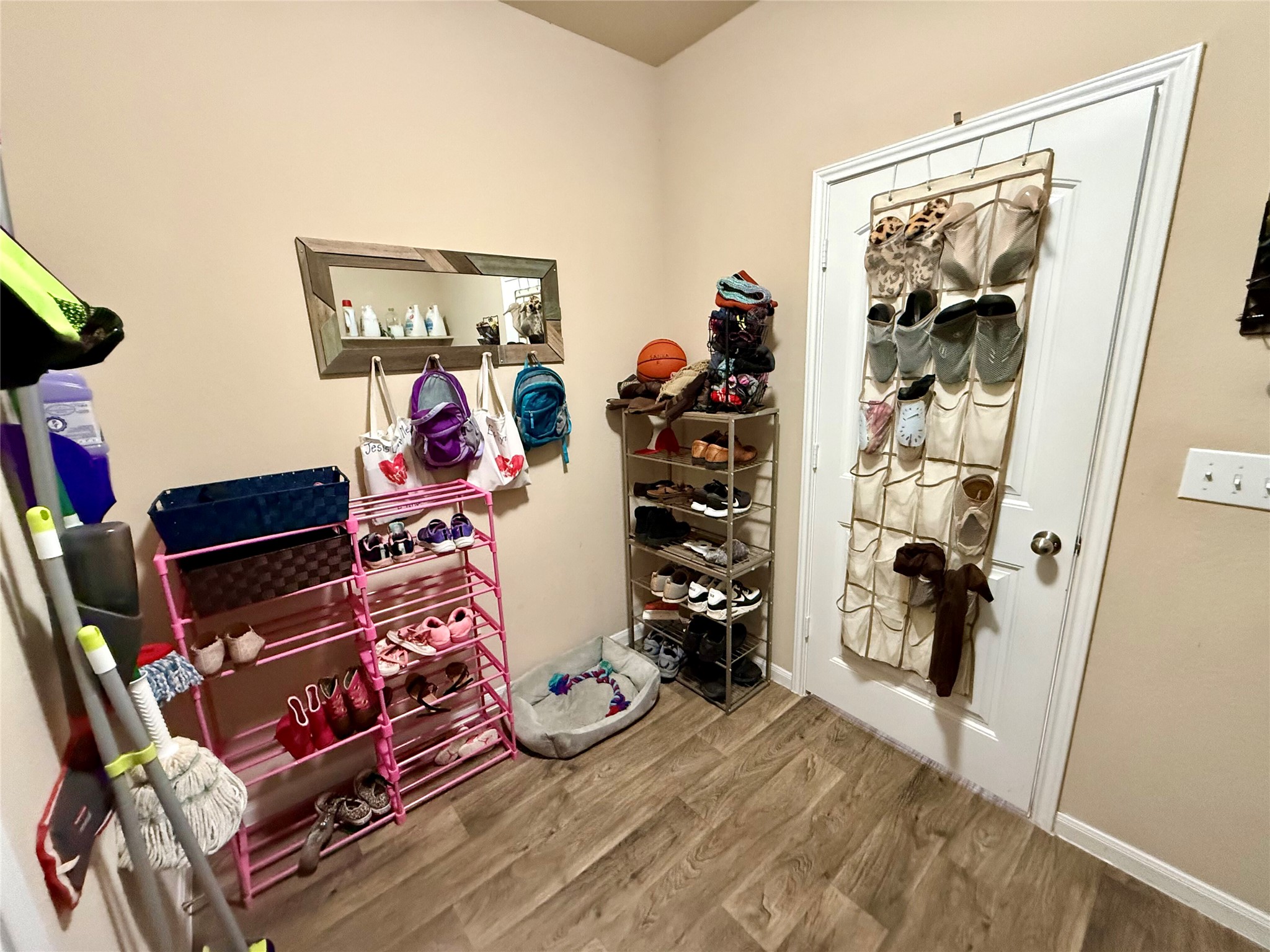 11700 Andesite Road Manor, TX 78653 - Photo 13 of 32 Functional mudroom with wood-look flooring and organized storage solutions.