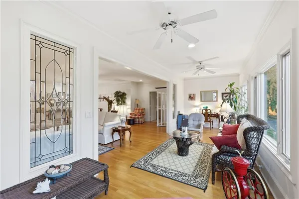 a living room with furniture and wooden floor