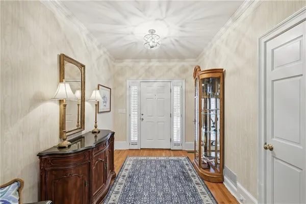 a view of a hallway to a livingroom with furniture
