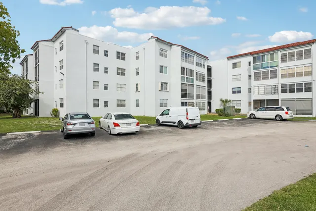 a cars parked in front of building with yard
