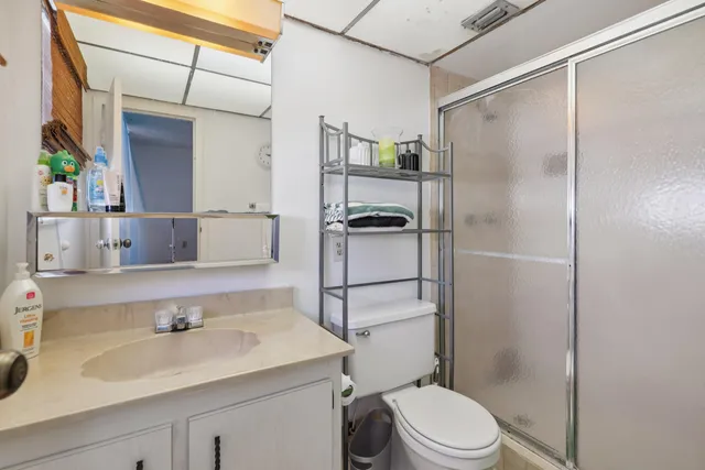 a bathroom with a sink toilet and shower