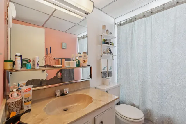 a bathroom with a sink toilet and shower