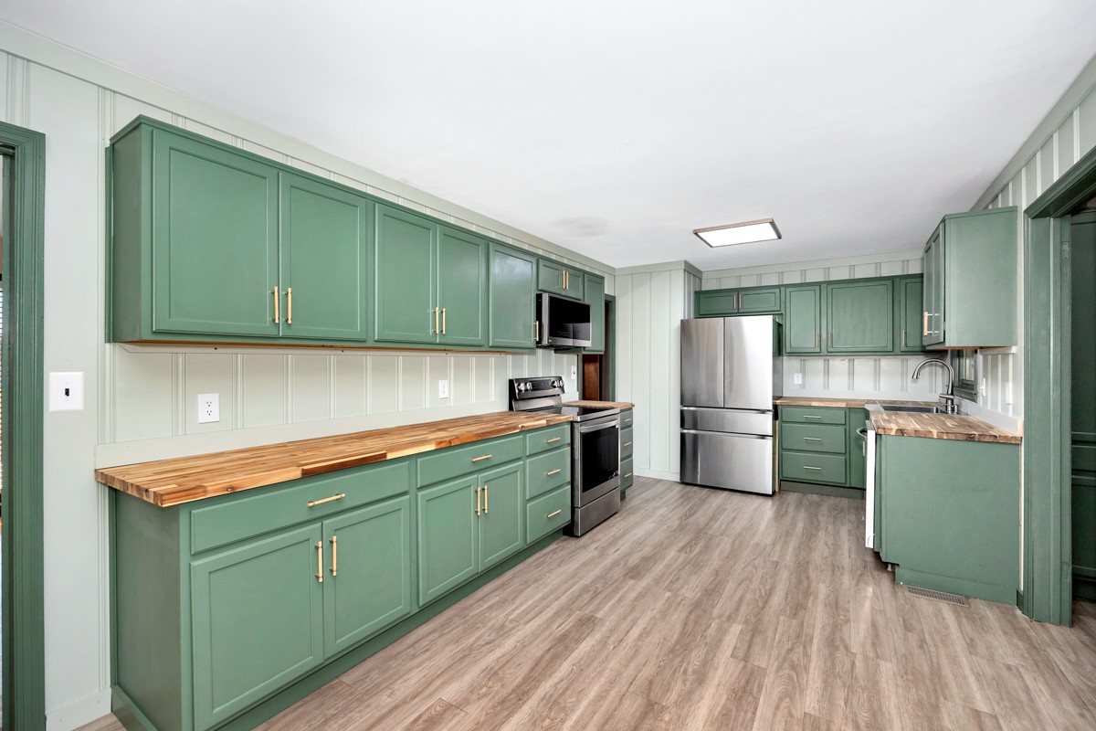 1969 Bobo Section Road Hazel Green, AL 35750 - Photo 17 of 47 a kitchen with stainless steel appliances white cabinets a sink and a stove