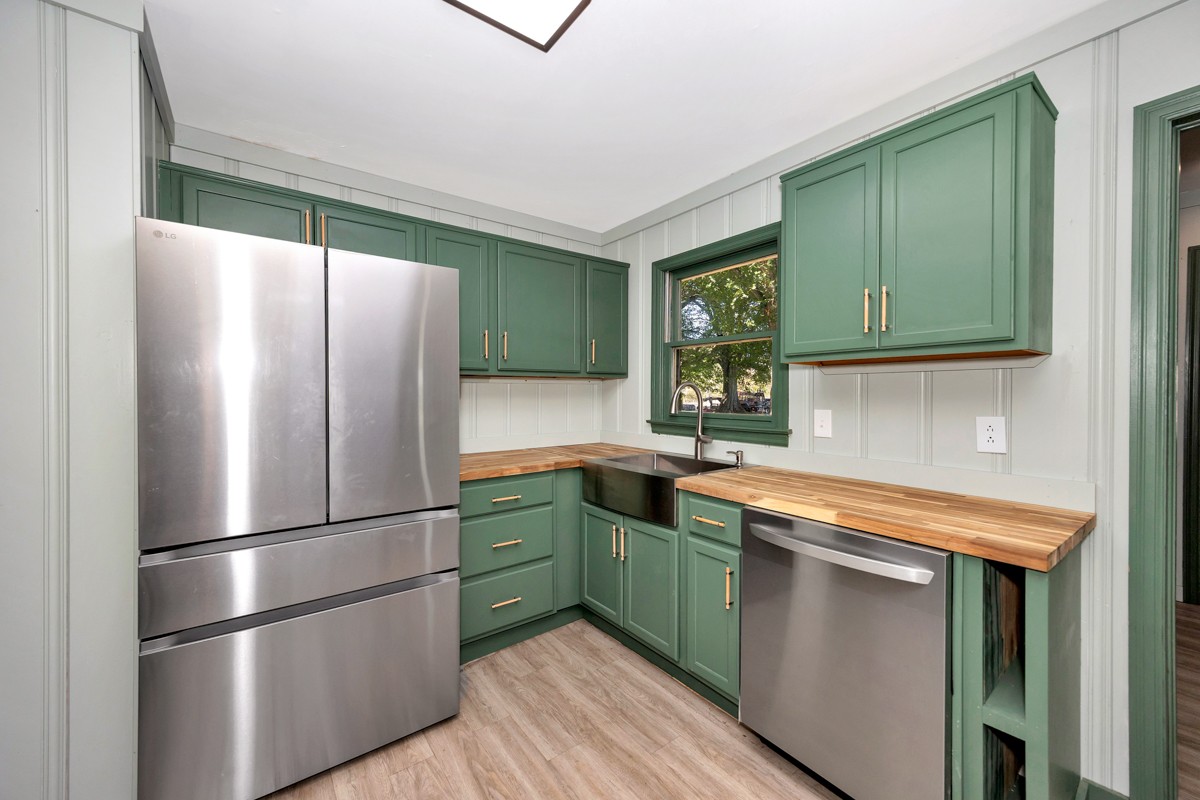 1969 Bobo Section Road Hazel Green, AL 35750 - Photo 19 of 47 a kitchen with stainless steel appliances granite countertop a refrigerator and a sink