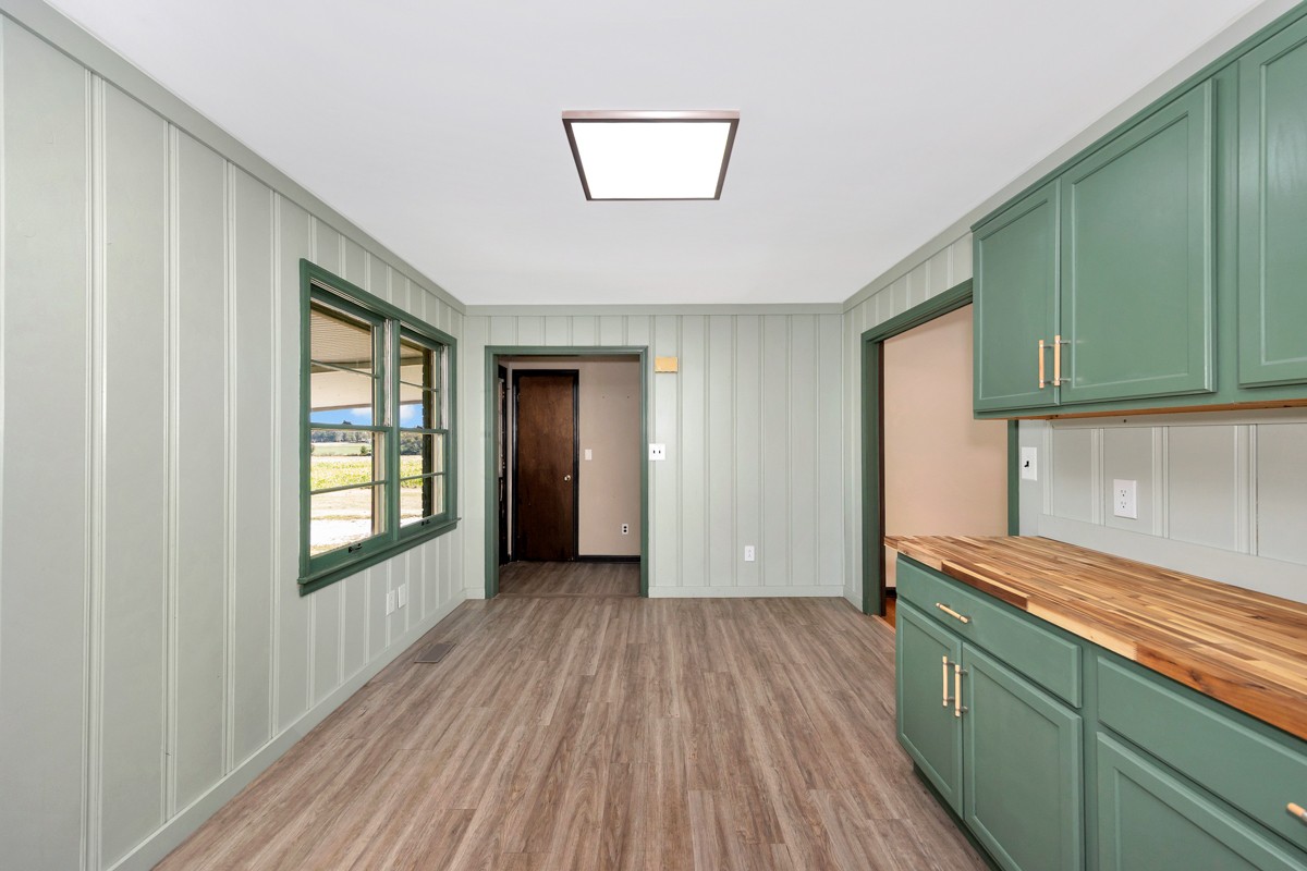 1969 Bobo Section Road Hazel Green, AL 35750 - Photo 20 of 47 a view of a hallway with wooden floor and cabinets