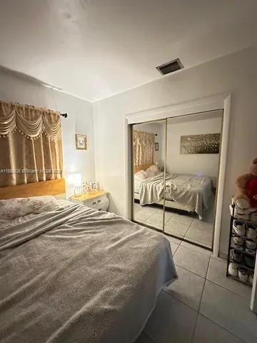 a bedroom with a bed and a fireplace