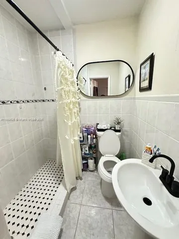a bath tub sitting next to a toilet