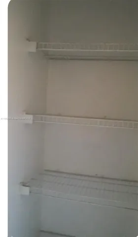 a view of a white house and a car parked front of it