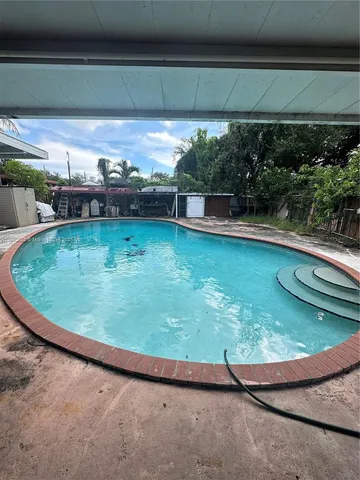 a view of a swimming pool with a yard