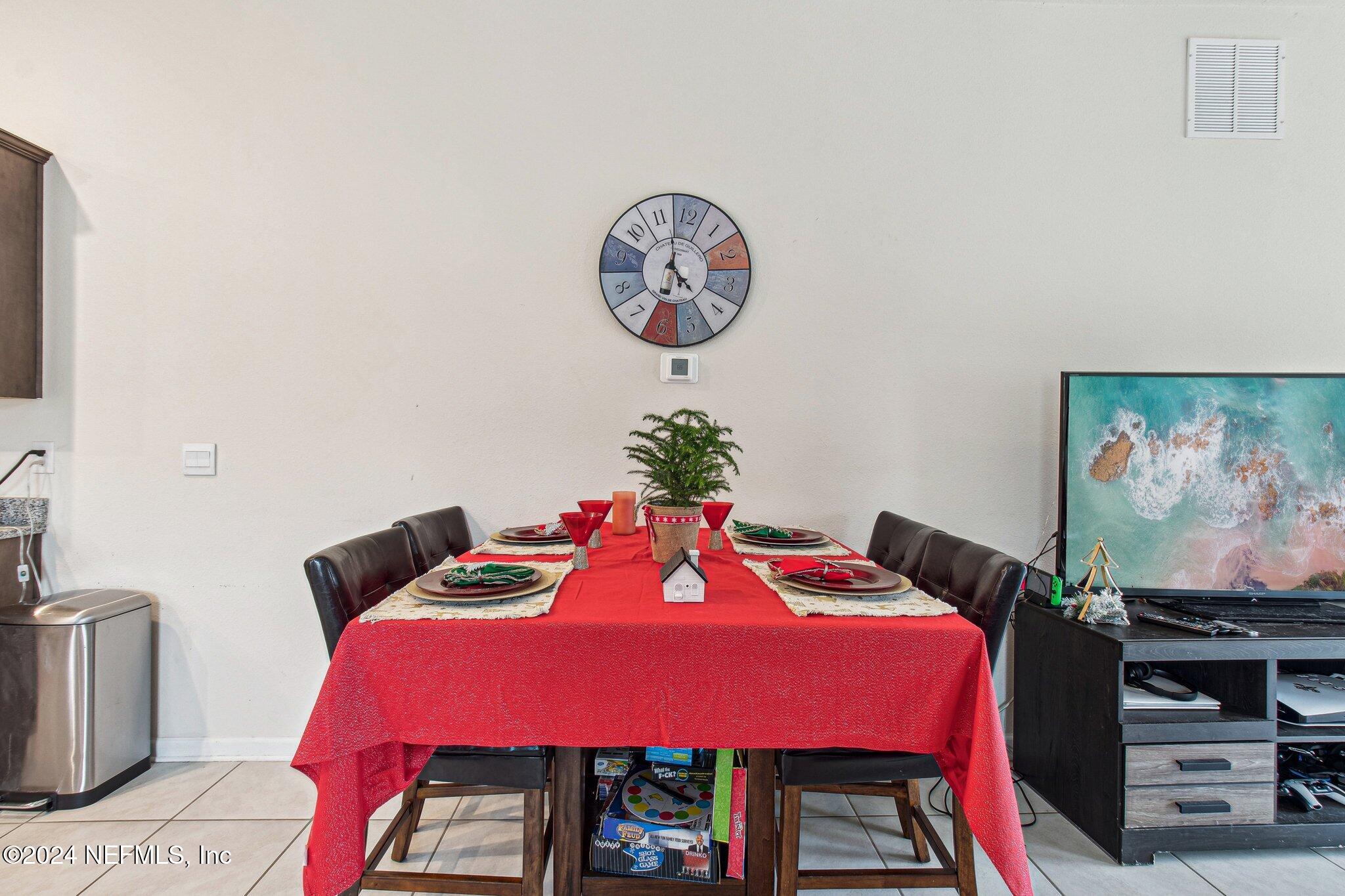 86253 Mainline Road Yulee, FL 32097 - Photo 11 of 39 a bedroom with a bed and a flat screen tv