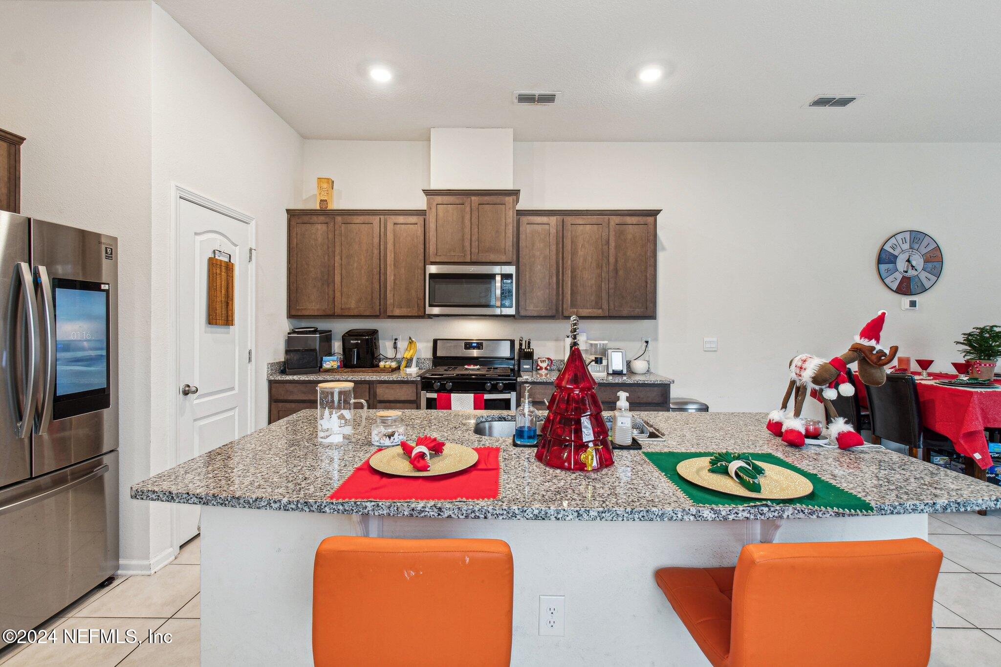 86253 Mainline Road Yulee, FL 32097 - Photo 15 of 39 a kitchen with stainless steel appliances granite countertop a stove and refrigerator