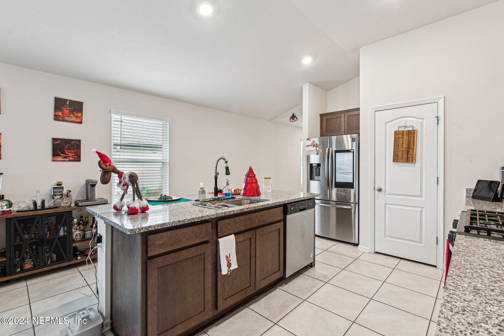86253 Mainline Road Yulee, FL 32097 - Photo 17 of 39 a utility room with cabinets dryer and washer