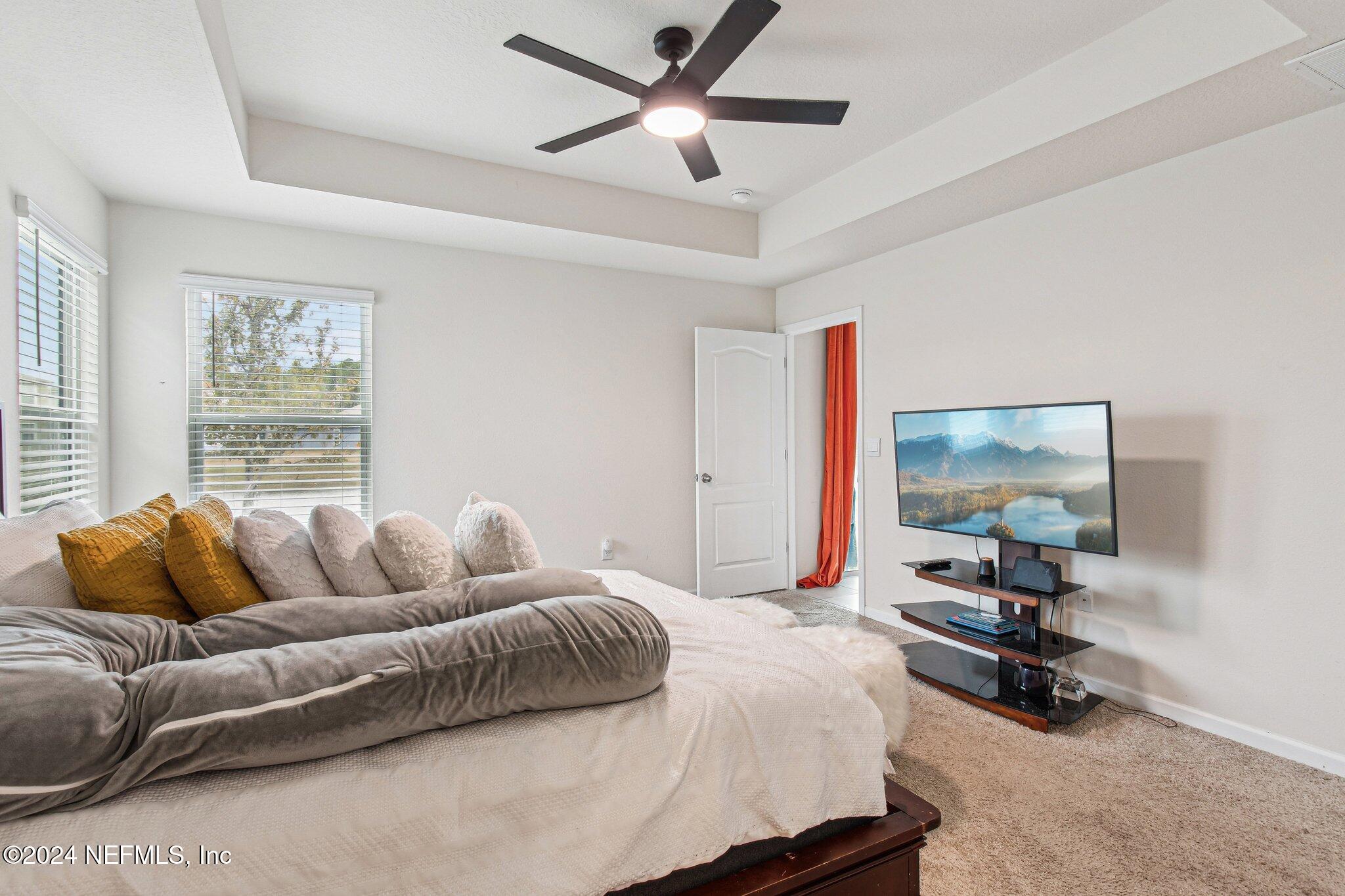 86253 Mainline Road Yulee, FL 32097 - Photo 23 of 39 a bedroom with a bed workspace and a window