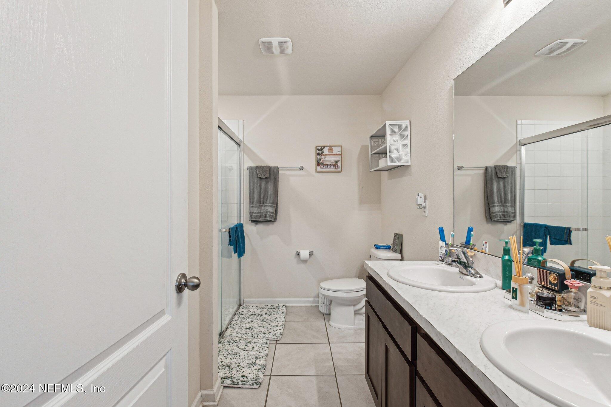 86253 Mainline Road Yulee, FL 32097 - Photo 24 of 39 a bathroom with a sink a toilet and shower