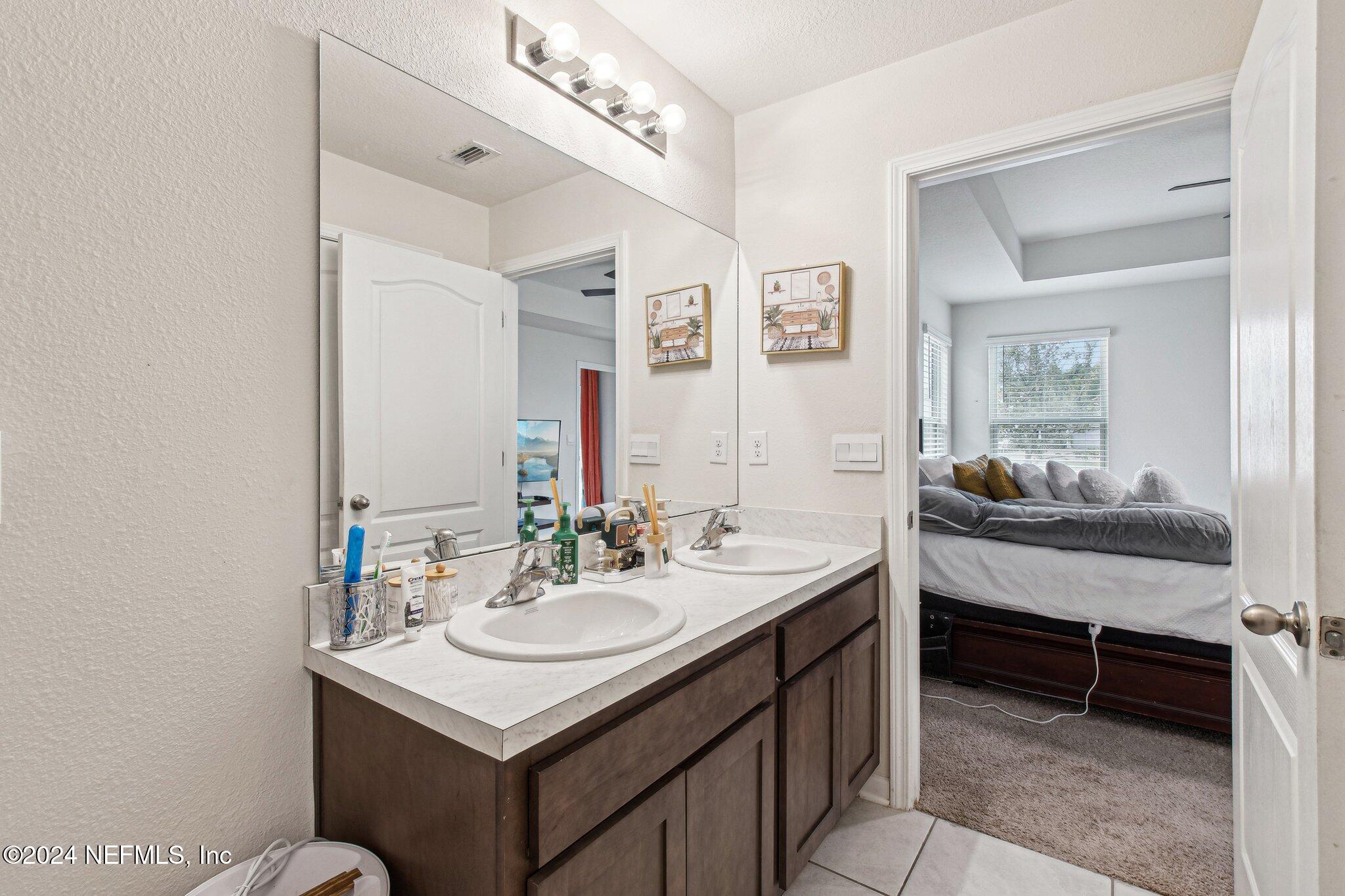 86253 Mainline Road Yulee, FL 32097 - Photo 26 of 39 a bathroom with a sink vanity and a mirror