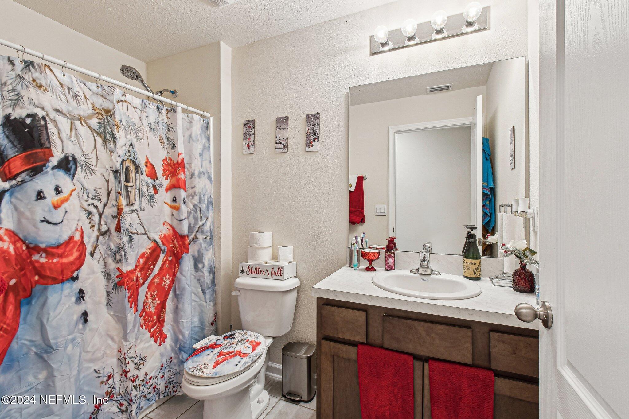 86253 Mainline Road Yulee, FL 32097 - Photo 27 of 39 a bathroom with a sink toilet and shower curtain