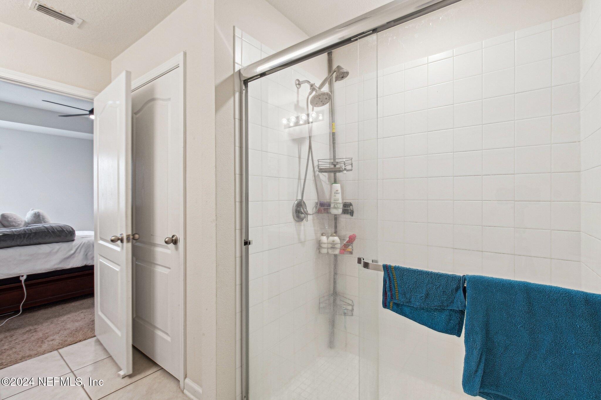 86253 Mainline Road Yulee, FL 32097 - Photo 33 of 39 a bathroom with a bathtub and a shower