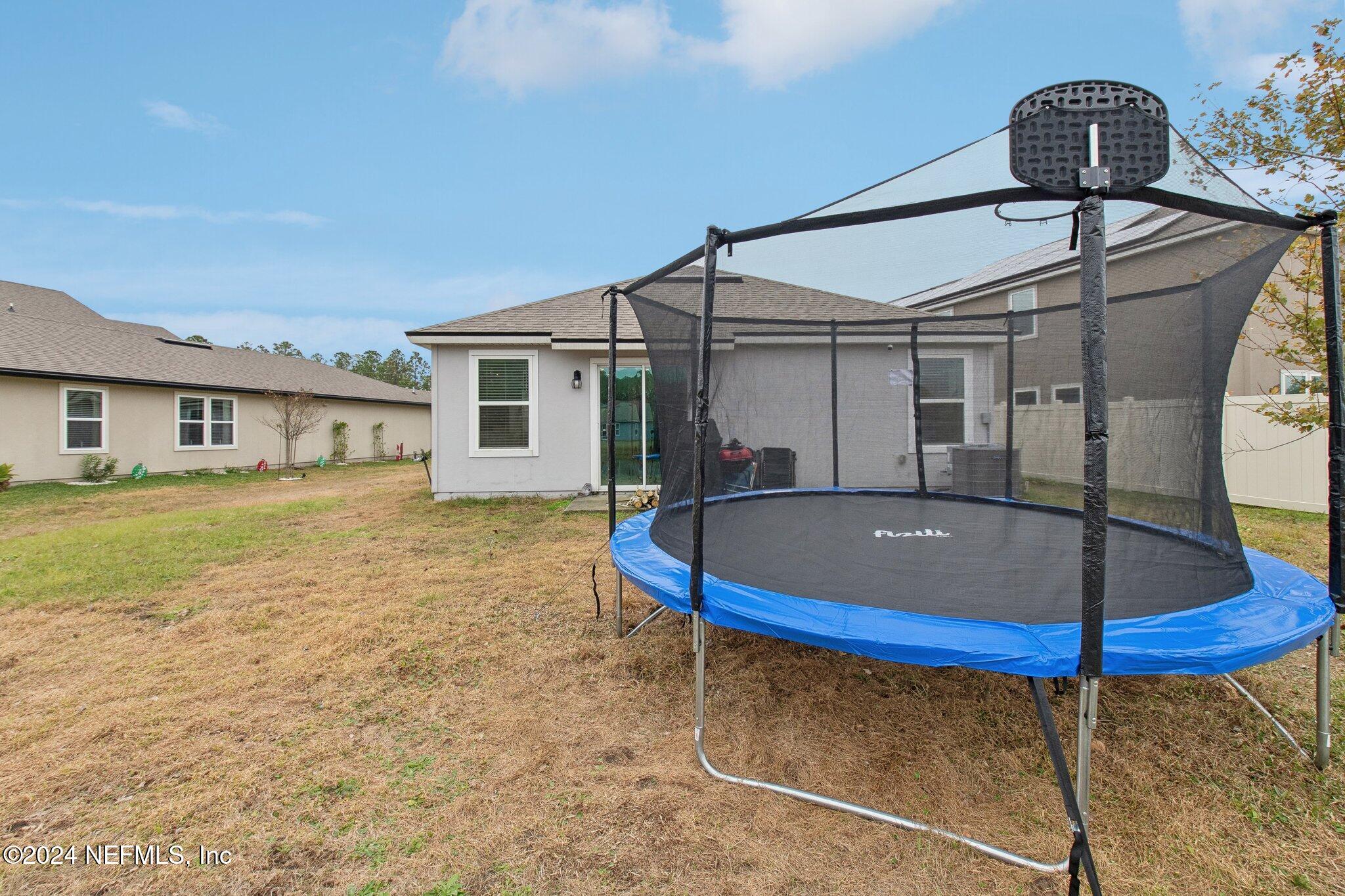 86253 Mainline Road Yulee, FL 32097 - Photo 36 of 39 a view of a house with swimming pool yard and porch