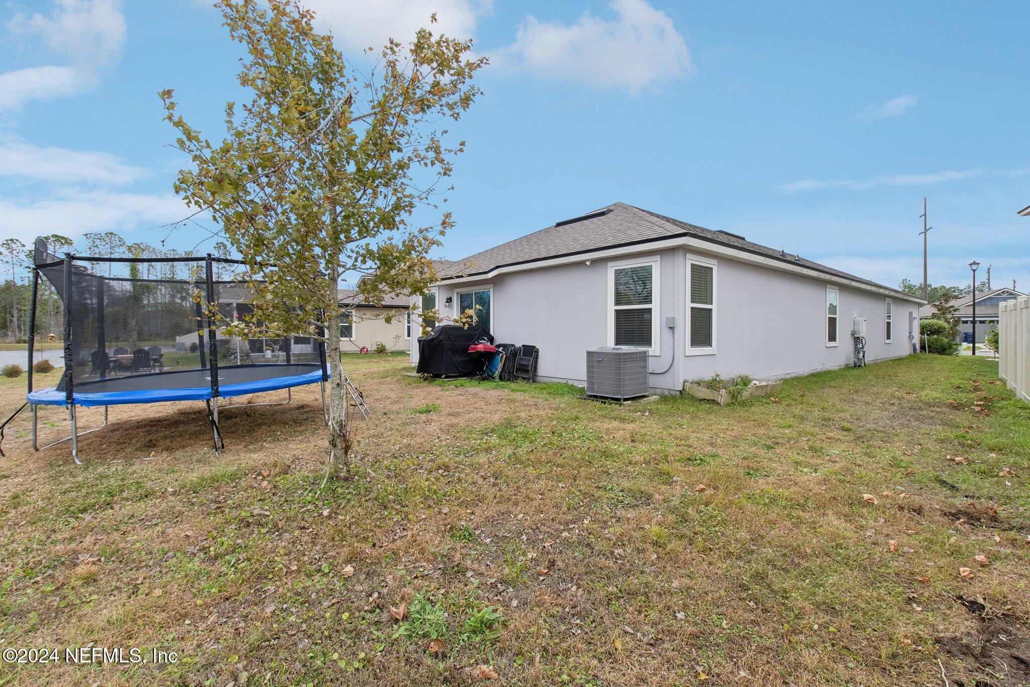 86253 Mainline Road Yulee, FL 32097 - Photo 38 of 39 a view of a house with a backyard