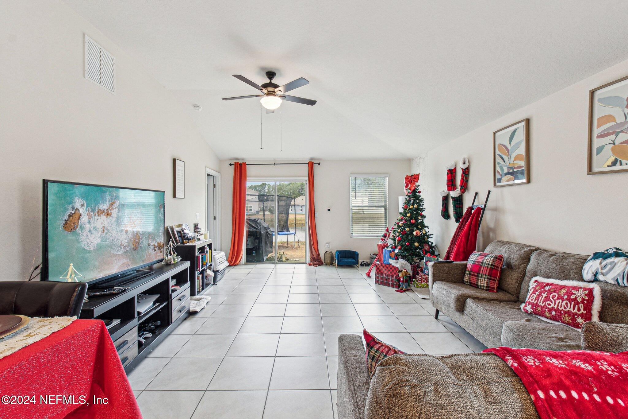 86253 Mainline Road Yulee, FL 32097 - Photo 7 of 39 a living room with furniture and a flat screen tv