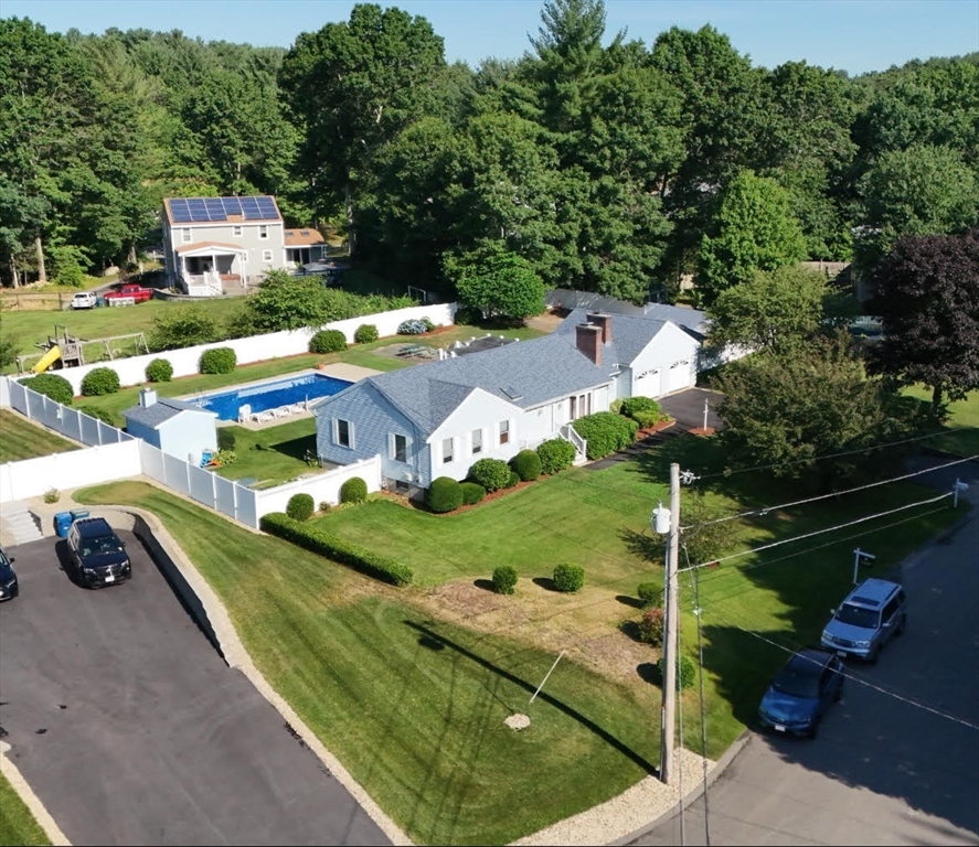 an aerial view of a house with garden space and street view