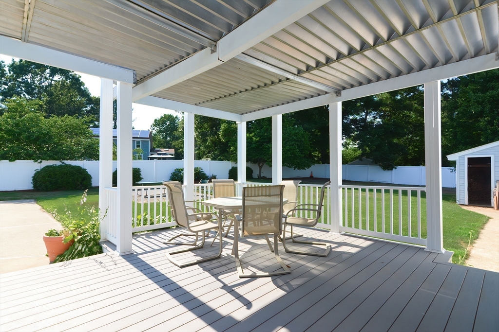 59 Breckenridge Road Tewksbury, MA 01876 - Photo 16 of 42 a view of a patio with table and chairs potted plants with wooden floor and fence
