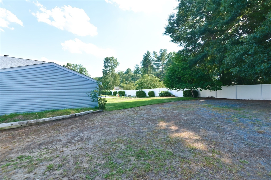 59 Breckenridge Road Tewksbury, MA 01876 - Photo 18 of 42 a view of a backyard with large trees
