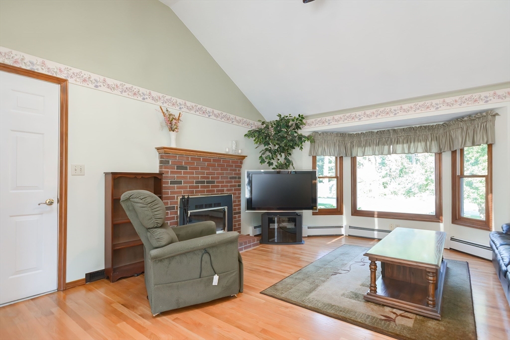 59 Breckenridge Road Tewksbury, MA 01876 - Photo 19 of 42 a living room with furniture a flat screen tv and a large window