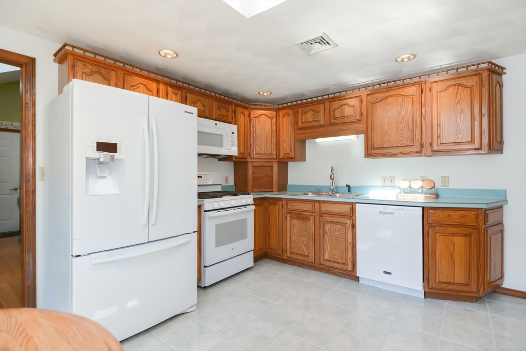 59 Breckenridge Road Tewksbury, MA 01876 - Photo 22 of 42 a kitchen with granite countertop appliances a sink and a refrigerator
