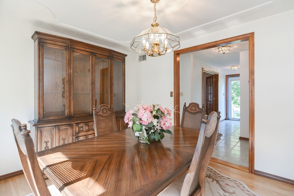 59 Breckenridge Road Tewksbury, MA 01876 - Photo 25 of 42 a view of a dining room with furniture and a chandelier