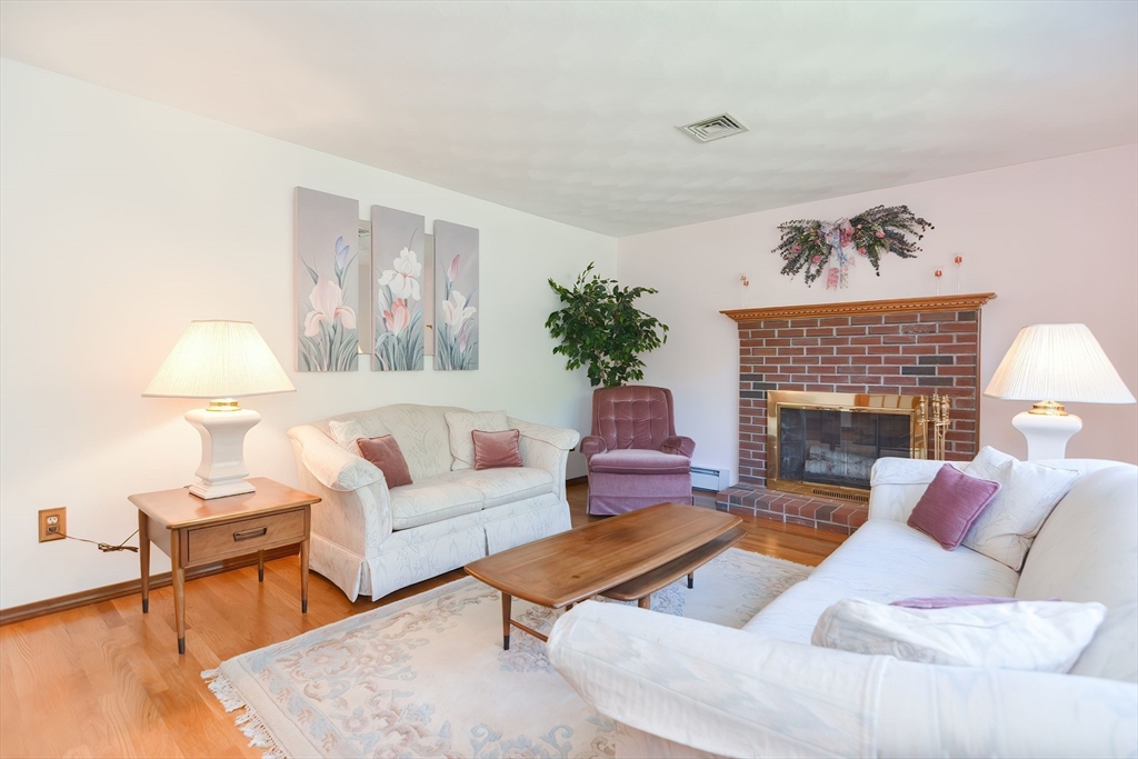 59 Breckenridge Road Tewksbury, MA 01876 - Photo 26 of 42 a living room with furniture a fireplace and a table
