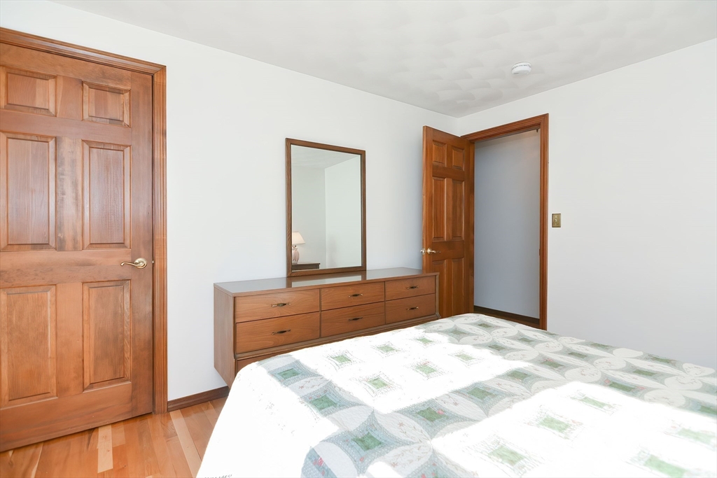 59 Breckenridge Road Tewksbury, MA 01876 - Photo 29 of 42 a bedroom with a bed and a mirror