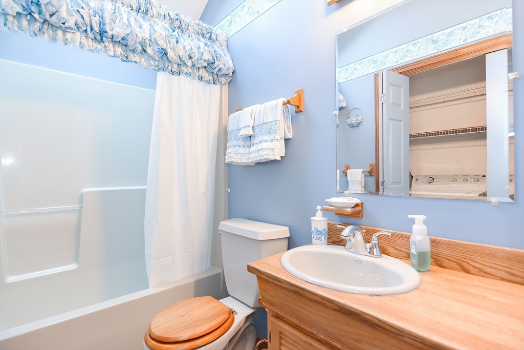 59 Breckenridge Road Tewksbury, MA 01876 - Photo 30 of 42 a bathroom with a toilet sink and mirror