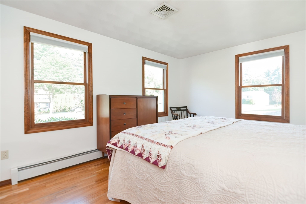59 Breckenridge Road Tewksbury, MA 01876 - Photo 35 of 42 a bedroom with a bed and wooden floor