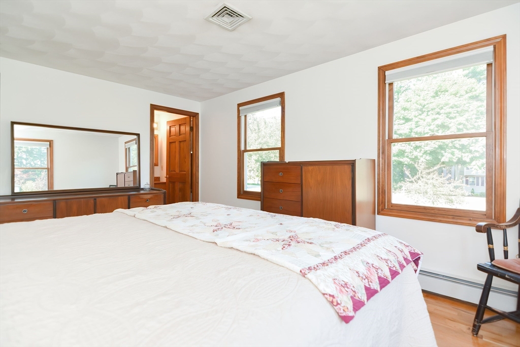 59 Breckenridge Road Tewksbury, MA 01876 - Photo 36 of 42 a bedroom with a large bed and wooden floor