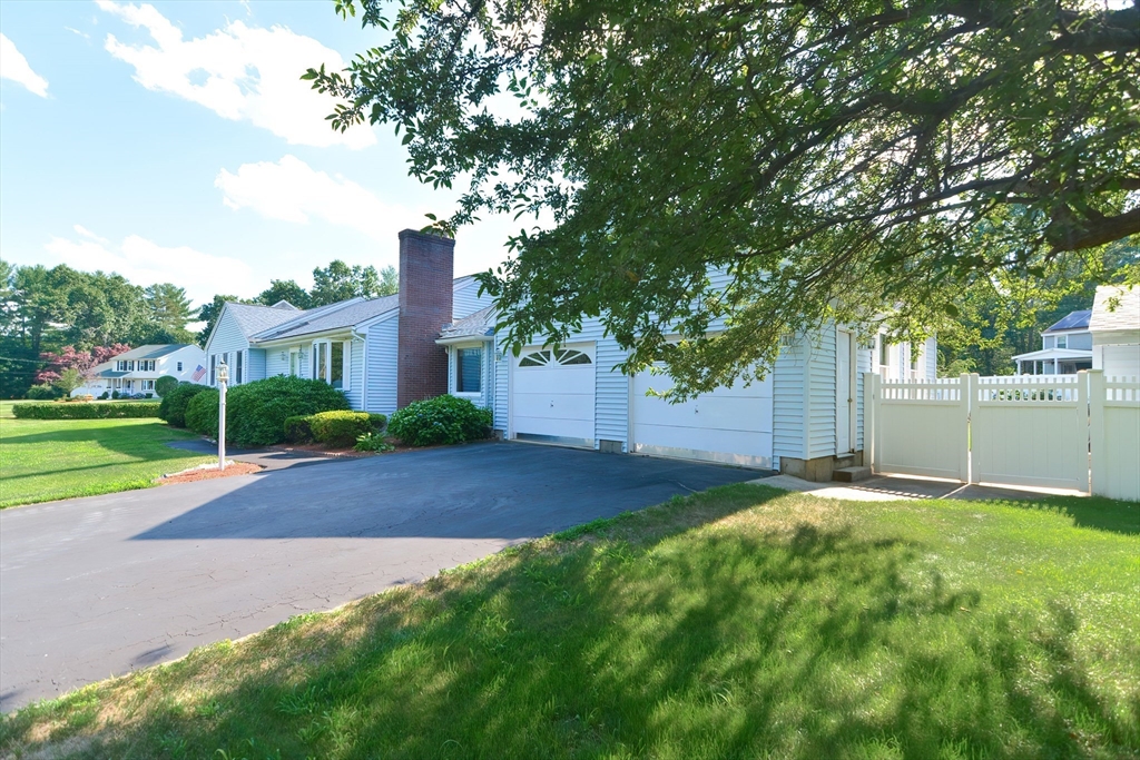 59 Breckenridge Road Tewksbury, MA 01876 - Photo 6 of 42 a view of a yard with plants and large tree