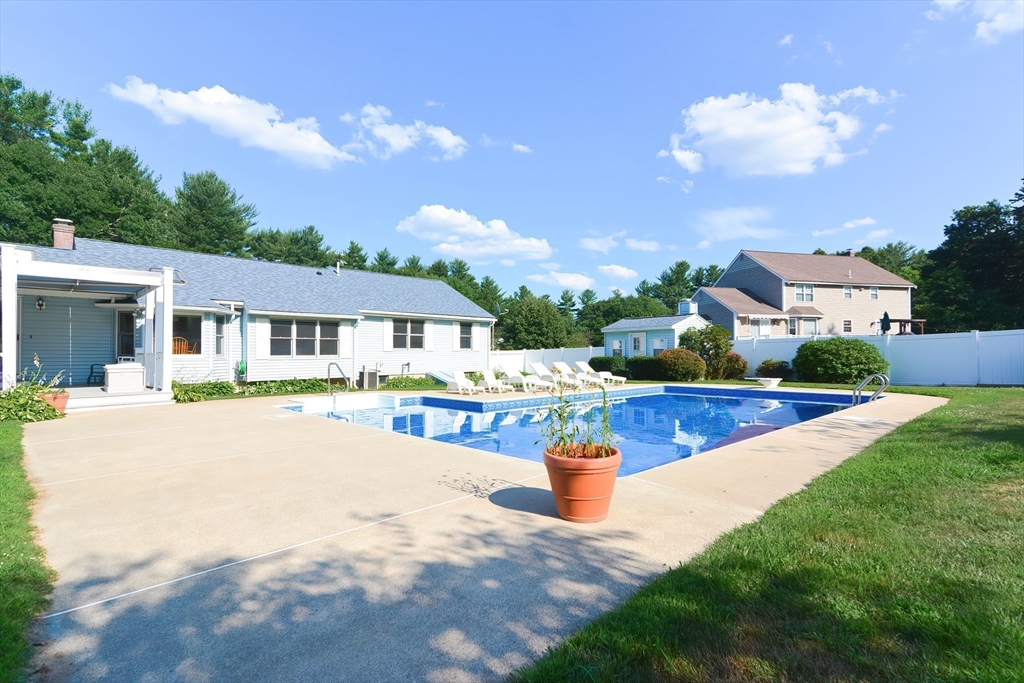59 Breckenridge Road Tewksbury, MA 01876 - Photo 9 of 42 a front view of a house with yard and garage