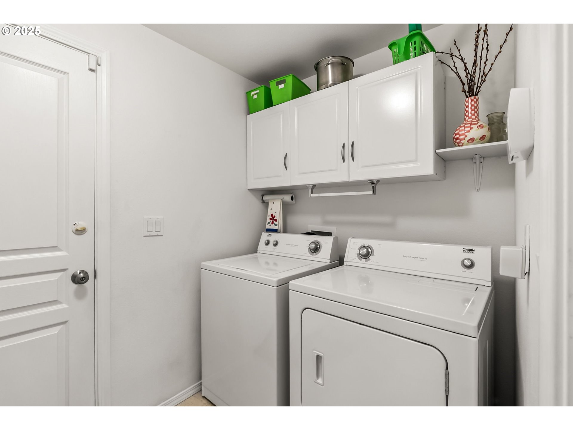 1933 South 58th Street Springfield, OR 97478 - Photo 22 of 32 a view of washer and dryer with kitchen in the background